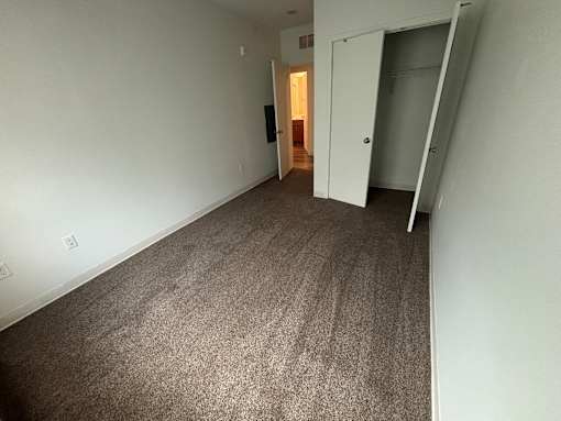 A room with carpeted floor and white walls.