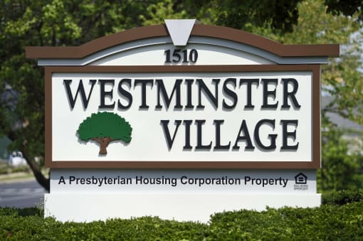 a sign is shown in front of trees