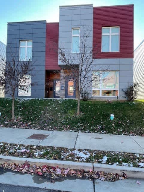 A modern house with a red and grey exterior.