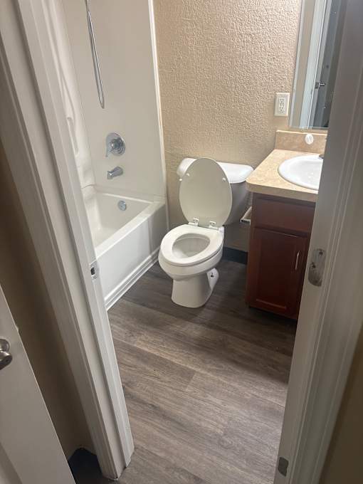A white toilet with a white tank is installed in a bathroom.