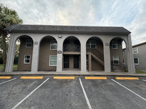 A building with a parking lot in front of it.
