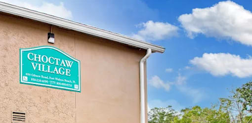 A sign on a building that says Choctaw Village.