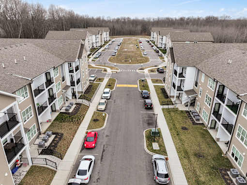 A parking lot in front of apartment buildings.