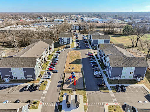 A parking lot in front of apartment buildings.