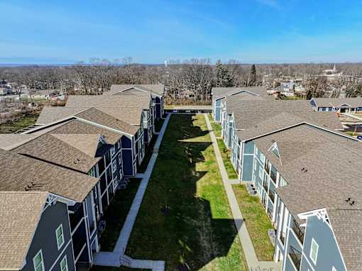 A long row of houses with a grassy area in the middle.