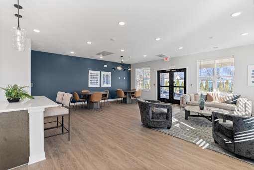 A spacious waiting area with a variety of seating options and a plant on the counter.