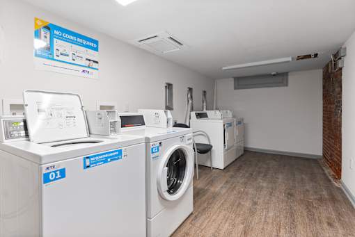 A laundromat with a sign that says "NO COINS REQUIRED".