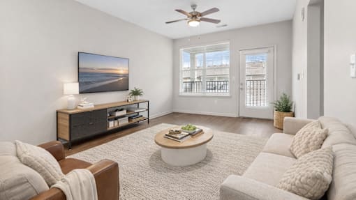 A living room with a brown couch, a coffee table, and a painting on the wall.