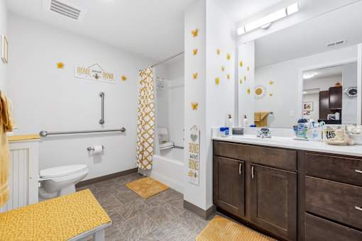 a bathroom with a toilet and a sink and a mirror