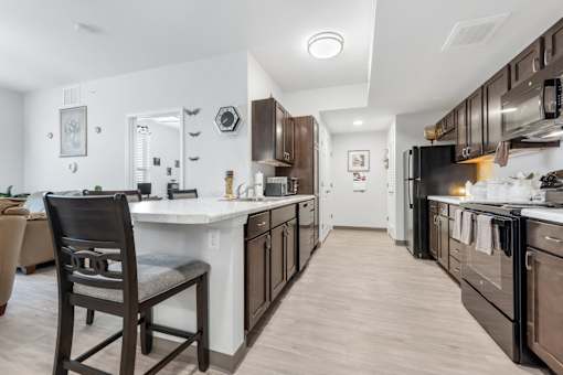 a kitchen with a large island and a stove and a refrigerator