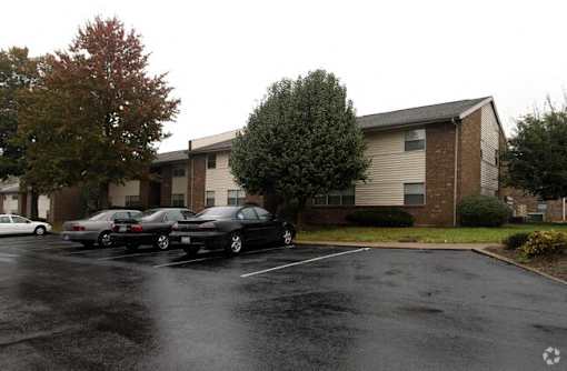 a parking lot with cars in front of a building