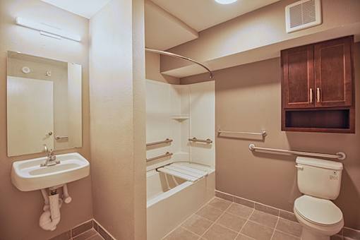 A bathroom with a toilet, sink, and bathtub.