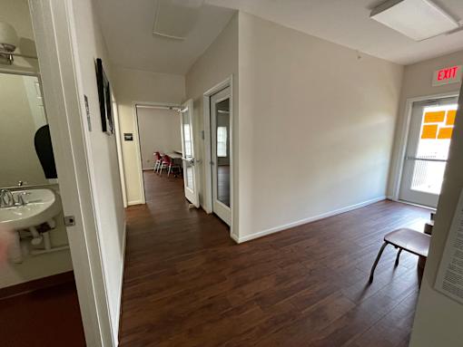 A room with a wooden floor and white walls.