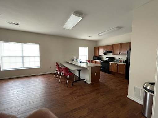 A kitchen with a table and chairs in the middle of the room.