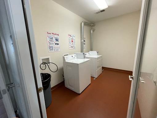A laundry room with a washing machine and a dryer.