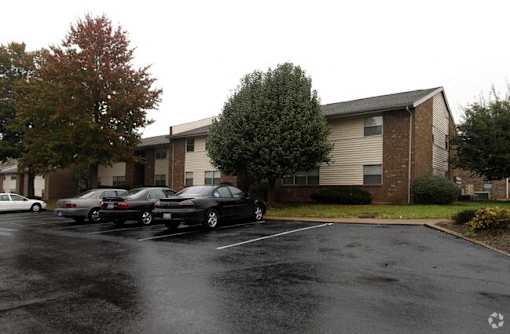 a parking lot with cars in front of a building