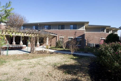 a brick house with a patio in front of it