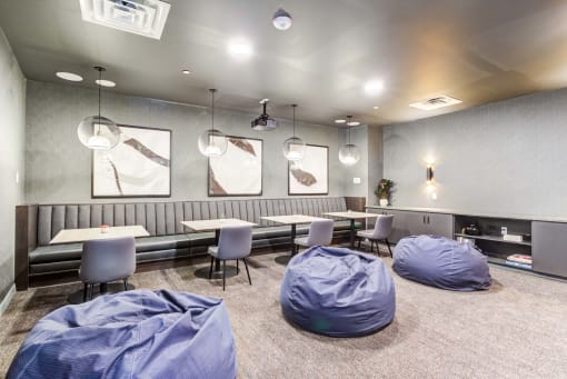 a room with beanbags and tables and chairs
