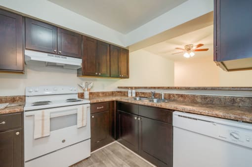 a kitchen with white appliances and granite counter tops