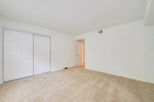 a room with white walls and a door and colorful lights on the wall