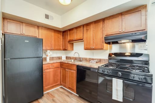 a large kitchen with stainless steel appliances and wooden cabinets