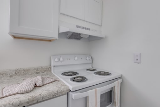 a kitchen with a stove and a counter with a sink