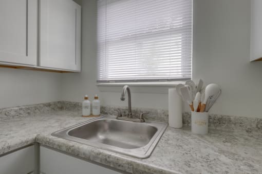 a kitchen with a sink and a window