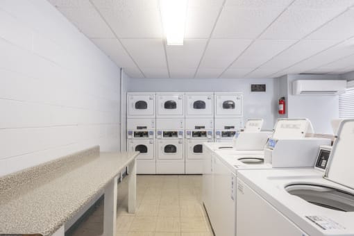 a laundry room with washers and dryers and washing machines