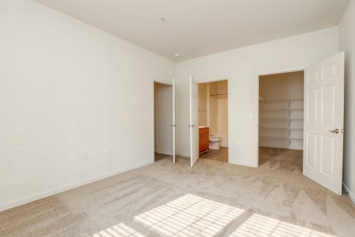 a bedroom with a closet and a bathroom with a toilet
