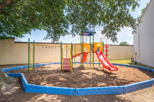 a playground with a playset and a tree