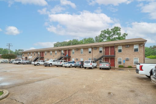 a large brick building with cars parked in front of it
