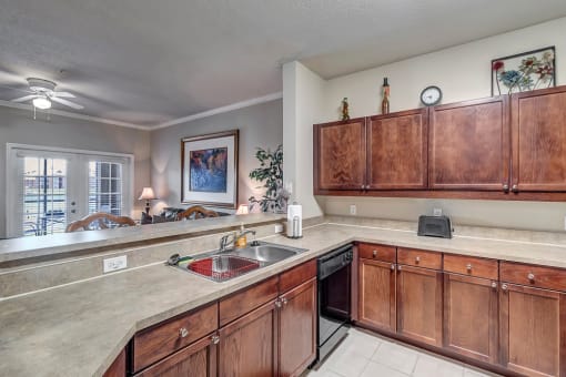 Kitchen with ample cabinets and dishwasher at Bermuda Estates Apartments in Ormond Beach, FL