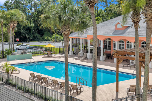 Large resort-style pool and covered patio at Bermuda Estates Apartments in Ormond Beach, FL