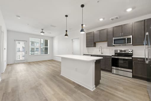 open floor plan with large kitchen island at Tapestry Overbrook in  McDonough, Georgia