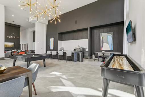 a game room with pool table and coffee lounge at Tapestry Headwaters in Kissimmee, FL