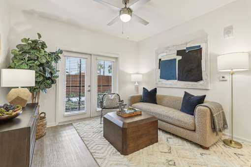 living room with designer plank flooring at Tapestry Headwaters Apartments in Kissimmee, FL