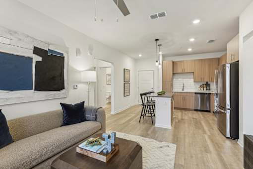open-concept living area with wood designed flooring at Tapestry Headwaters in Kissimmee, FL