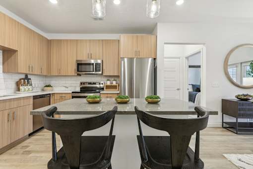 island kitchen with modern lighting at Tapestry Headwaters in Kissimmee, FL