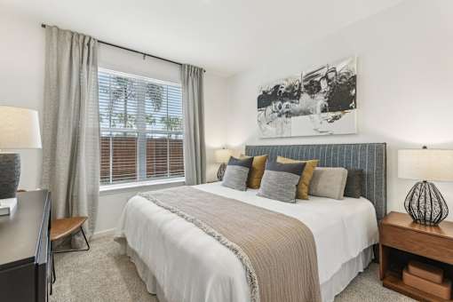 a bedroom with a large bed and a window at Tapestry Headwaters in Kissimmee, FL