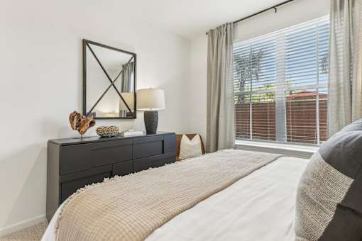 a bedroom with a large bed and a large window at Tapestry Headwaters in Kissimmee, FL