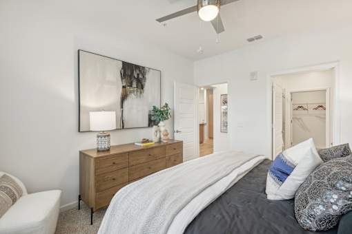 bedroom with ceiling fan and large walk in closet