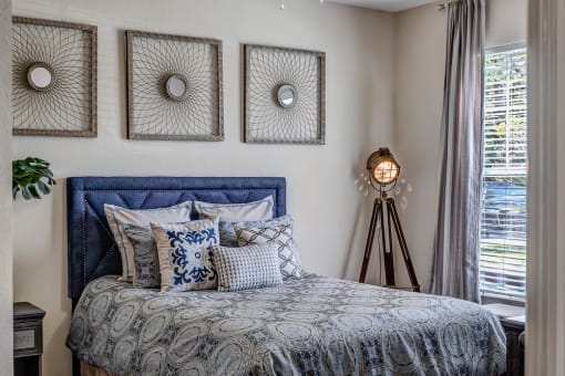 Guest bedroom with large window at Bermuda Estates Apartments in Ormond Beach, FL