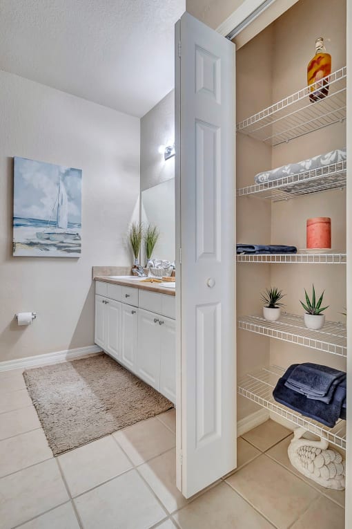 bathroom with tile floor and linen closet at Bermuda Estates Apartments in Ormond Beach, FL