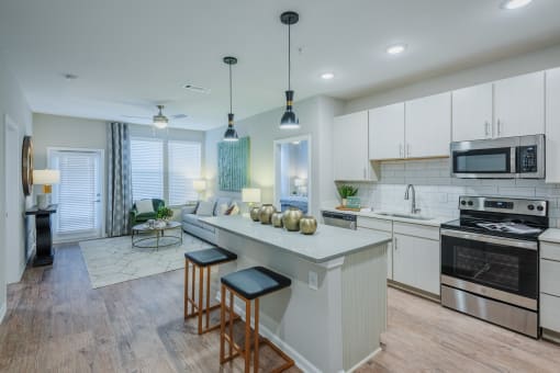 kitchen with custom cabinets, large island, and stainless steel appliances at Bon Haven Apartments in Spartanburg, SC