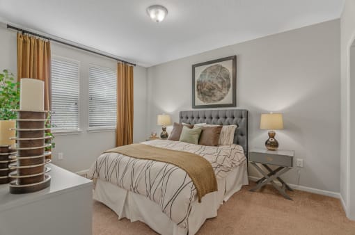 a bedroom with a bed and two windows