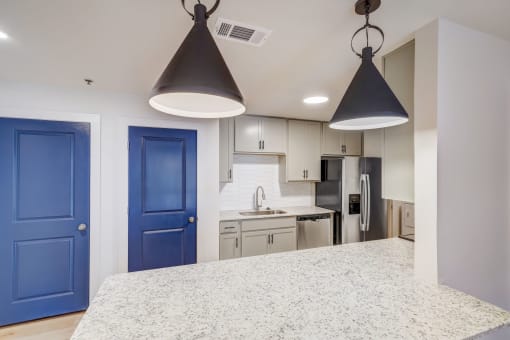 a kitchen with blue doors and a white counter top