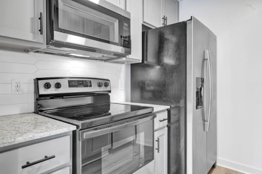 a kitchen with stainless steel appliances and a refrigerator
