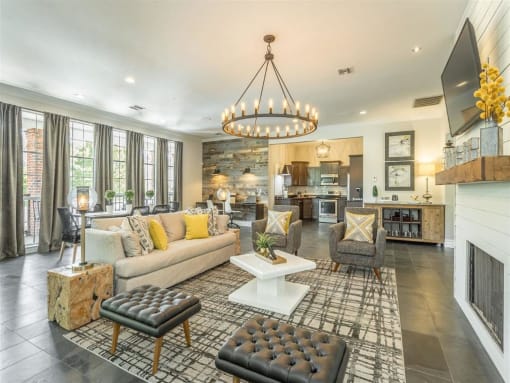 the living room has a fireplace and a wall of windows
