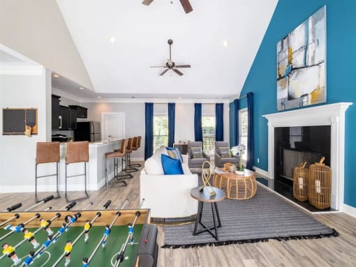 a living room with a pool table and a bar