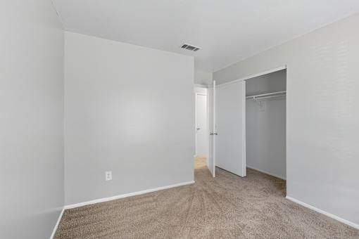 A room with a carpeted floor and white walls.